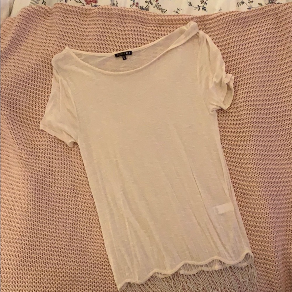 White top with beaded accents on hem